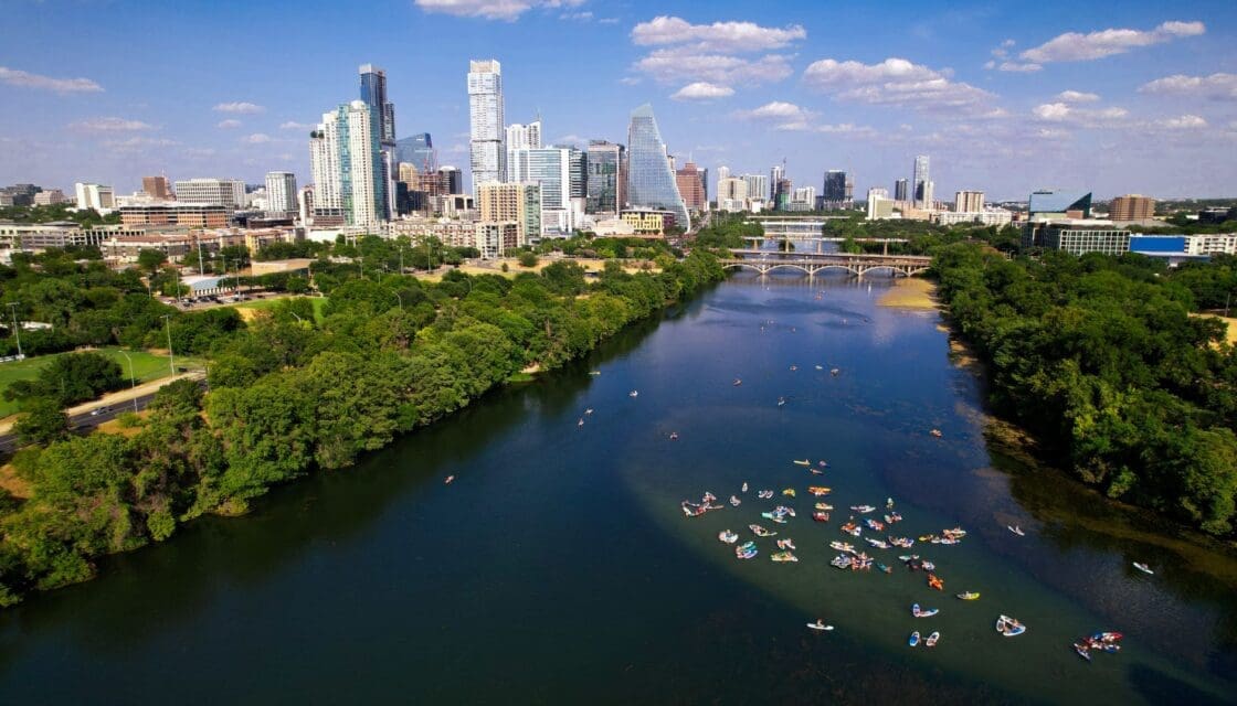austin with kids — kayaks on the Colorado River with Austin skyline