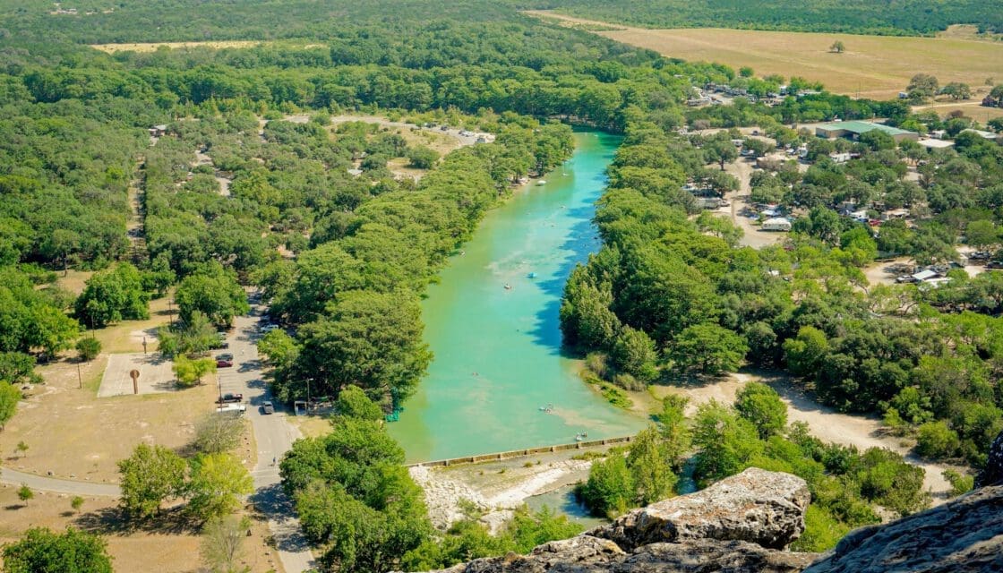 Concan Texas with kids — aerial view of the Frio River winding through dense Hill Country cedar and oak