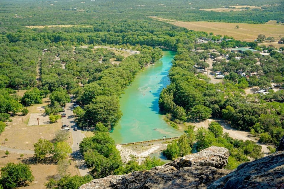 Concan Texas with kids — aerial view of the Frio River winding through dense Hill Country cedar and oak