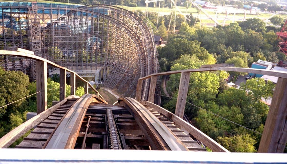 Six Flags Over Texas with kids — wooden roller coaster towering above the Arlington park on a clear day