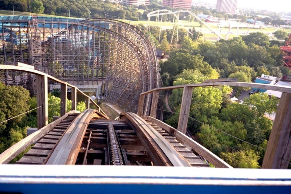 Six Flags Over Texas with kids — wooden roller coaster towering above the Arlington park on a clear day